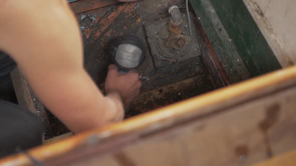 Drying bilge of old wooden boat checking for water leaks