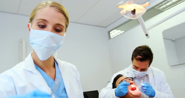 Dentists giving anesthesia to male patient