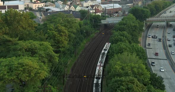 Aerial Following Shot of a Train Near the Highway in New Rochelle