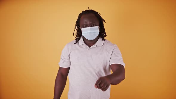 African American Black Man with Medical Mask and Braidd Hair Pointing Finget Towards the Camera