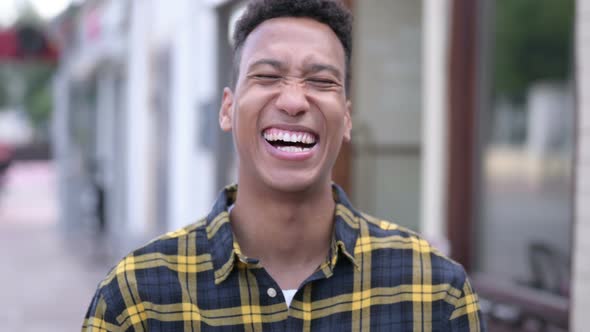 Outdoor Portrait of Laughing Young African Man