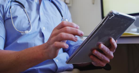 Doctor working and using digital tablet in a retirement home