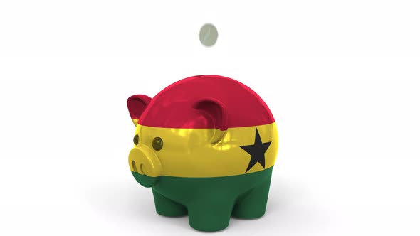Coins Fall Into Piggy Bank Painted with Flag of Ghana