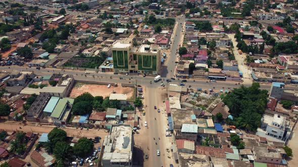 Cinematic Rising Aerial View of African City traffic, showing Twin Towers building, Lomé, West Afric