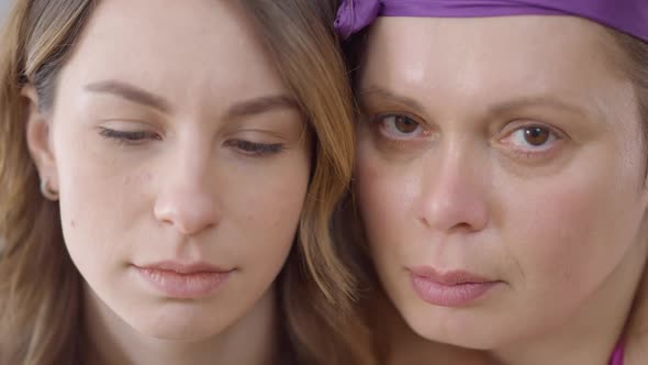 Closeup Faces of Slim and Fat Caucasian Young Women Looking at Camera Smiling