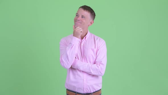 Portrait of Happy Businessman Thinking and Looking Up