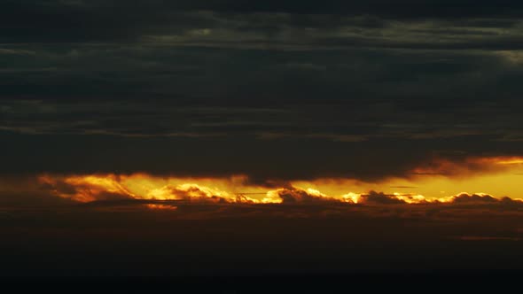 Sun Setting Behind Orange Parting Clouds