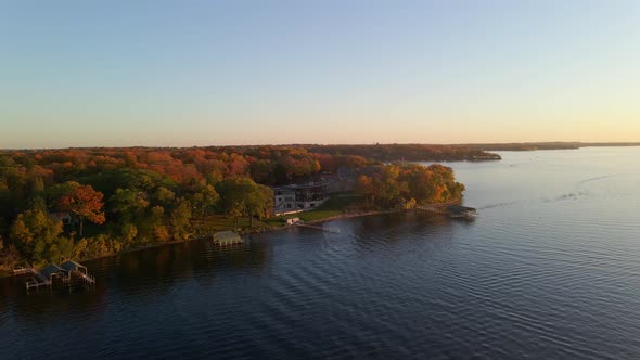 aerial view of a home surrounded by colorful trees during autumn color peak