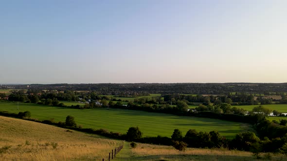 Verdant meadows in English countryside, Berkshire county in UK. Aerial forward