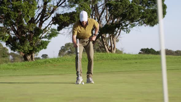 Golf player hitting the ball with his club