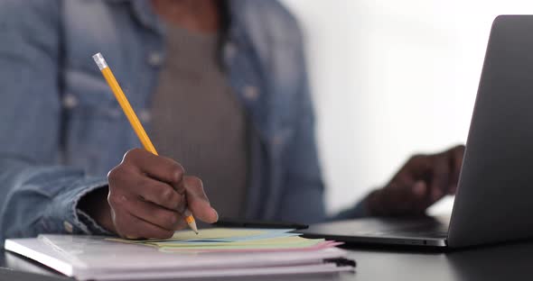 Young woman working at home, using digital tablet and pencil, close-up