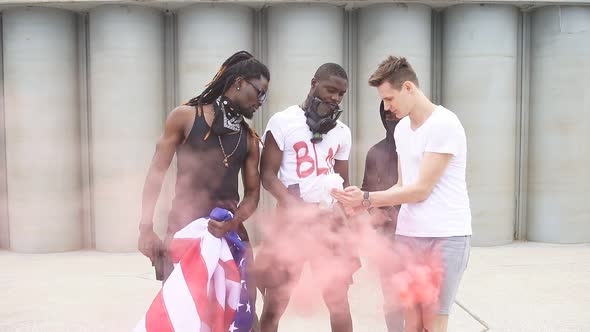 Group of Protesting Men Prepare for Protests, Light a Molotov Cocktail