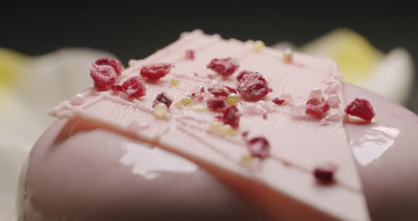 Delicious Sweet Natural Round Dessert with Pink Cream on a Black Background