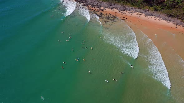 Top View Of Several Surfers On Turquoise Ocean At Noosa National Park Near Noosa Heads In QLD, Austr