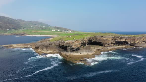 People are Climbing on the Cliffs at Muckross Head County Donegal  Ireland