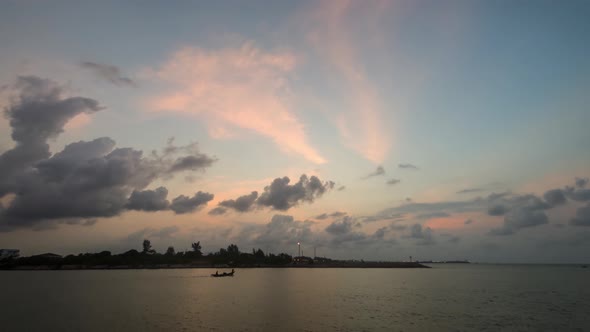 A timelapse of a dramatic sunrise from night till dusk with clouds moving into the shot and sun reve alt