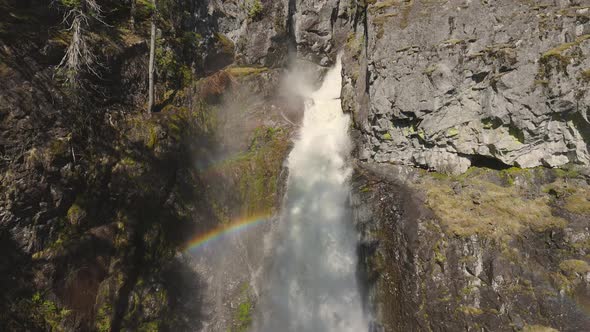 Waterfall Rushing Down a Rocky Canyon in the Canadian Mountains