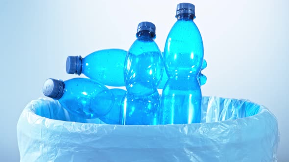 Super Slow Motion Shot of Empty Plastic Bottles Falling Into Trash Can at 1000Fps