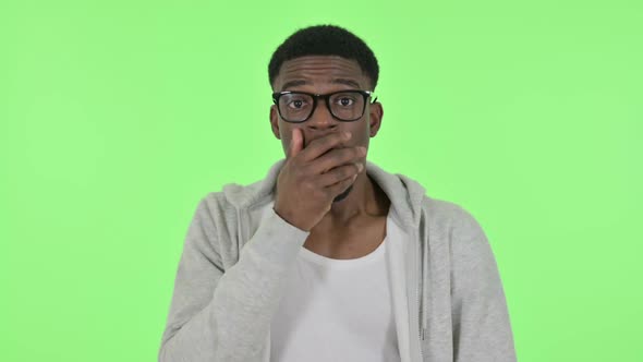 Shocked African Man on Green Background