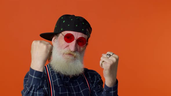 Mature Grandfather Raising Fists in Gesture I Did It Celebrating Success Winning Goal Achievement