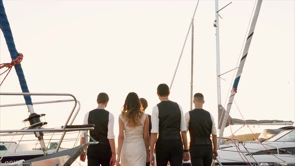 People Walking in Harbour at Sunset