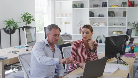 Colleagues discussing about something on the computer