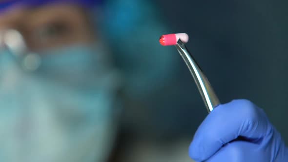 Lab Worker Holding Capsule in Forceps, Pharmaceutical Industry Inventions, Test