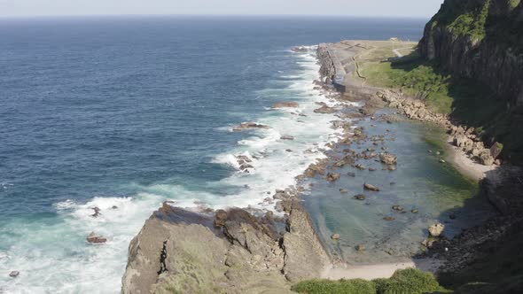 Aerial Cinematic Nature waves, ocean and Rocks Formations Keelung Wangyou Valley Taiwan.