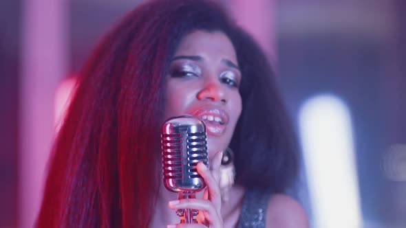 Luxury Party Portrait of a Young African Female Singing in a Nightclub Closeup of a Woman's Face in