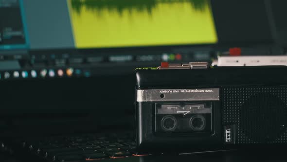 Record Audio on Mini Tape Recorder Against Laptop with Audio Recording Spectrum