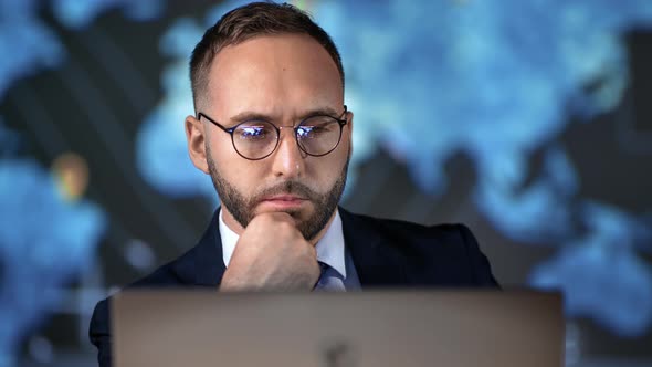 Focused Business Man in Suit Working Use Laptop Planning Commercial Deal at Hi Tech Office