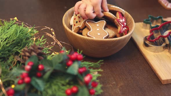 Unrecognizable Child Hand Takes Fresh Baked Decorated Christmas Cookie Pastry