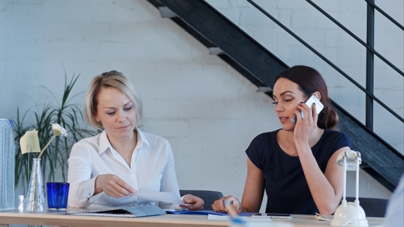 Female workers are working in office having phone calls