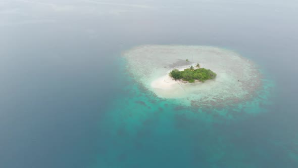 Aerial: flying over desert island tropical beach caribbean sea turquoise water c