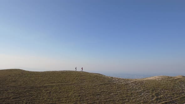 Drone view of two friends hiking in the Apennines, Umbria, Italy