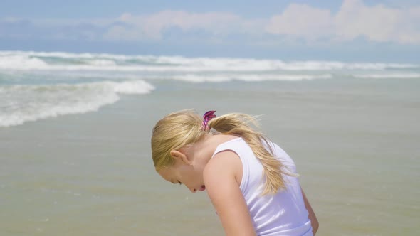 Girl Looking at Sea with Wind in Her Hair. Beautiful Blond Hair Develops in the Wind and She Is