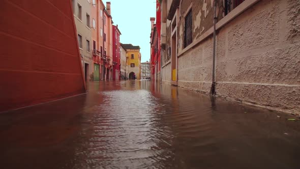 Flooded road between colored houses