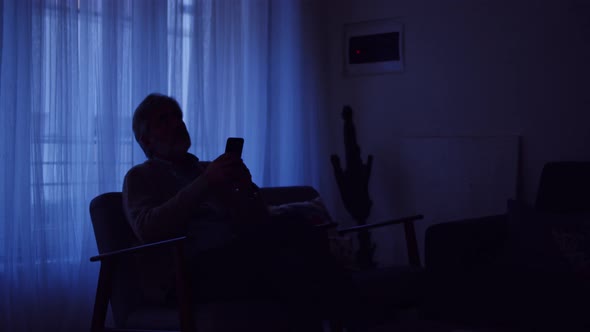 Slow motion shot of man using remote control to operate smart home