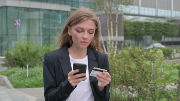 Young Businesswoman Making Online Payment on Smartphone