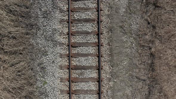 Flying backwards and above old railroad track 4K drone footage