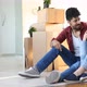 Young Couple Unpacking Cardboard Boxes at New Home Moving in Concept - VideoHive Item for Sale