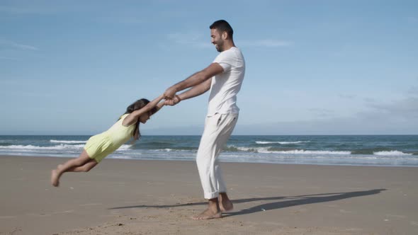 Mom Having Fun with Daughter on Beach