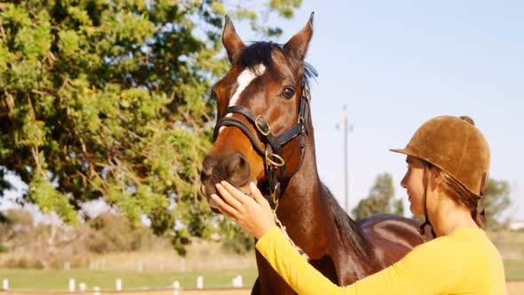 Woman standing with the horse in the ranch 4k