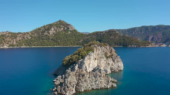 Rock Island in the Sea on Background of Mountains in Blue Bay Marmaris Icmeler Turkey
