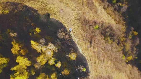 Camera Turns Around Above Bride on Hill with Yellow Grass