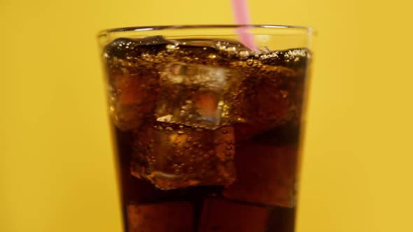 Mixing Cola Cocktail with Drinking Straw