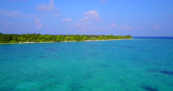 Daytime aerial island view of a paradise sunny white sand beach and blue ocean background in colorfu