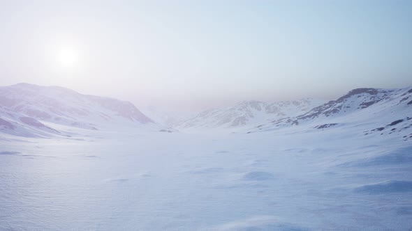 Aerial Landscape of Snowy Mountains and Icy Shores in Antarctica