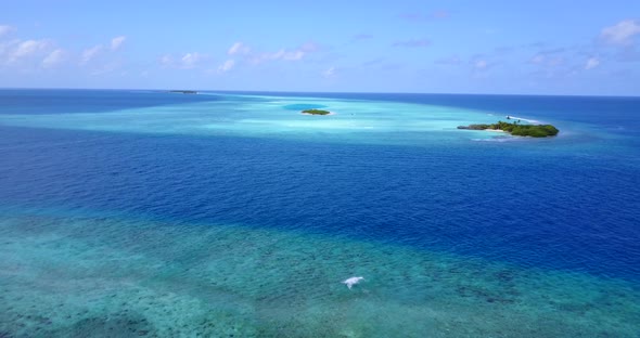 Wide angle above abstract view of a white paradise beach and aqua turquoise water background in 4K