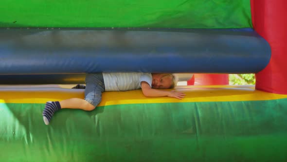 Boy coming out from bouncing castle